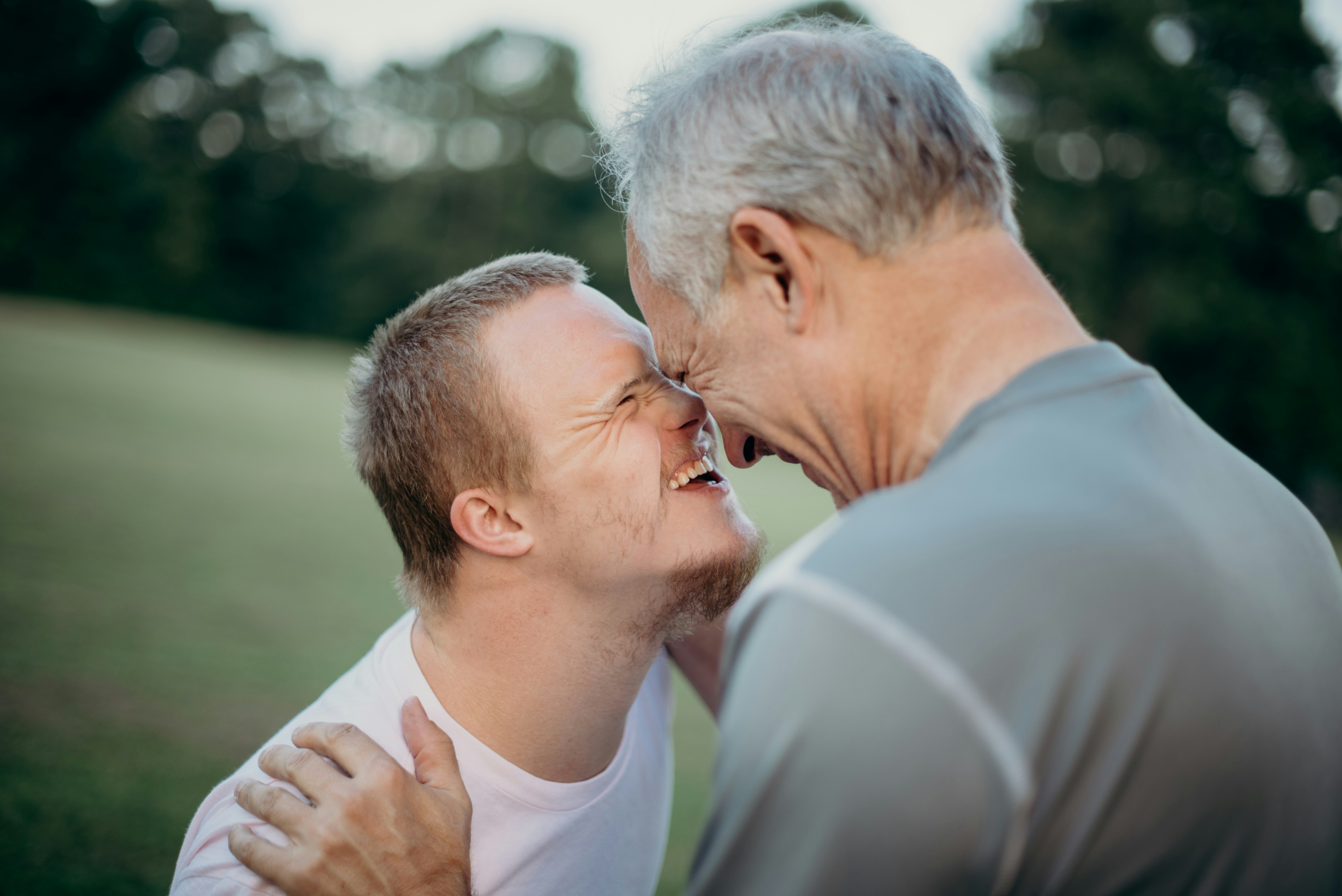 Father and son with disability sharing a joyful moment outdoors